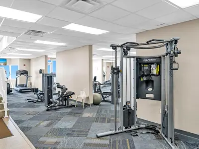 a gym with several treadmills and machines at Tidewater 2115 in Panama City Beach
