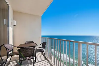 a balcony with a table and chairs and the ocean at Tidewater 2115 in Panama City Beach
