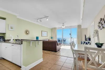 a kitchen and dining room with a view of the ocean at Tidewater 2115 in Panama City Beach