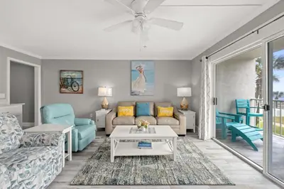 a living room with a couch and a table at The Summit 228 in Panama City Beach