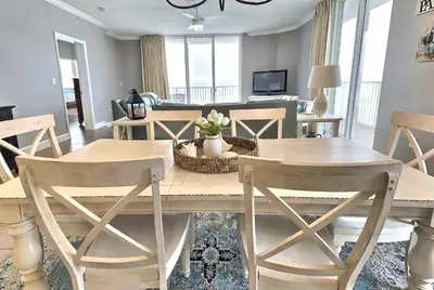 a dining room with a table and chairs at Happy Ours 2200 sq ft corner beachfront sleeps 12 in Panama City Beach