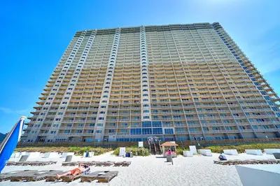 a large building with a beach in front of it at Amazing Sunset Oceanfront Condo in Panama City Beach