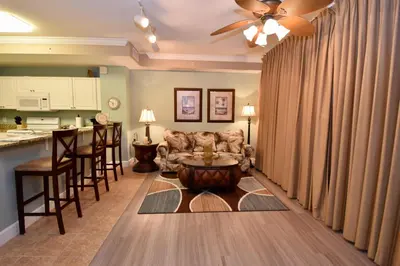 a living room with a couch and a table at Amazing Sunset Oceanfront Condo in Panama City Beach