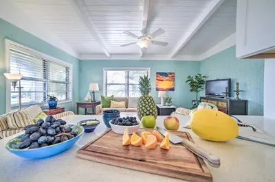 a living room with a table with fruit on it at Walk to Beach PCB Retreat with Private Pool! in Panama City Beach