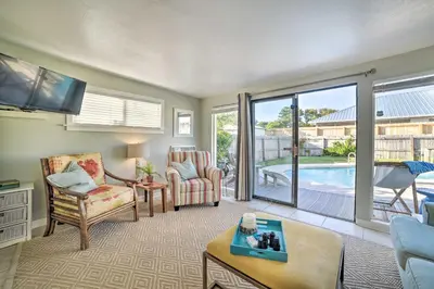 a living room with a view of a pool at Walk to Beach PCB Retreat with Private Pool! in Panama City Beach