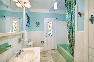 a bathroom with a sink and a toilet and a shower at Walk to Beach PCB Retreat with Private Pool! in Panama City Beach