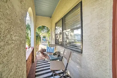 a balcony with two chairs and a table and a window at Walk to Beach PCB Retreat with Private Pool! in Panama City Beach
