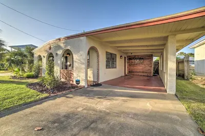 a house with a garage with a driveway at Walk to Beach PCB Retreat with Private Pool! in Panama City Beach