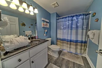 a bathroom with a sink and a toilet and a shower at Calming Beachfront Condo with Oversized Balcony Facing the Gulf - Unit 2101 in Panama City Beach