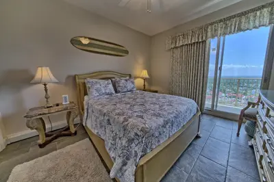 a bedroom with a bed and a large window at Calming Beachfront Condo with Oversized Balcony Facing the Gulf - Unit 2101 in Panama City Beach