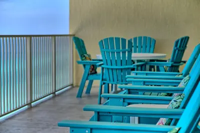 a row of blue chairs sitting in a room at Calming Beachfront Condo with Oversized Balcony Facing the Gulf - Unit 2101 in Panama City Beach