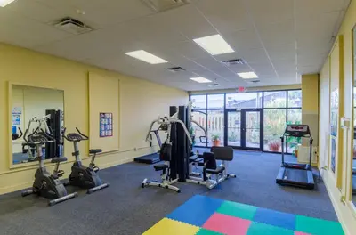 a gym with several treadmills and elliptical machines at Sunbird 0208W 'Surfside Sandcastle' in Panama City Beach