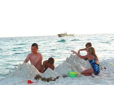 a group of people playing in the sand on the beach at Sunbird 0208W 'Surfside Sandcastle' in Panama City Beach