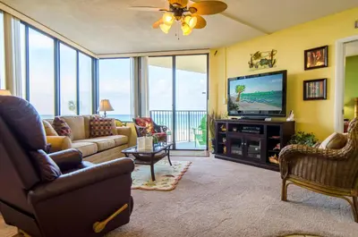 a living room with a couch and a television at Sunbird 0208E 'Dolphin Watch' in Panama City Beach