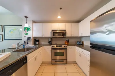 a kitchen with white cabinets and a stainless steel appliance at Grand Panama 1-1706 'Paradise Harbor' in Panama City Beach