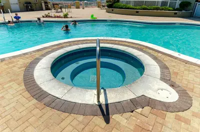 a swimming pool with people in the water at Grand Panama 1-1706 'Paradise Harbor' in Panama City Beach
