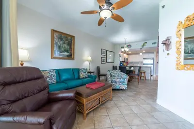 a living room with a couch and a ceiling fan at Grand Panama 1-1706 'Paradise Harbor' in Panama City Beach