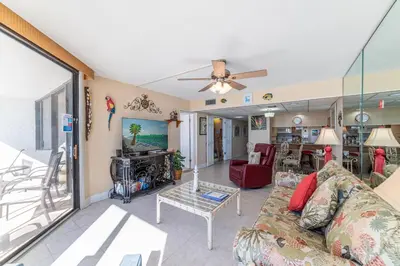 a living room with a couch and a ceiling fan at Edgewater W404 'Sandpiper' in Panama City Beach