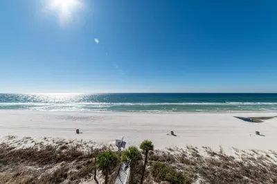 a beach with people on the sand and the ocean at Edgewater W404 'Sandpiper' in Panama City Beach