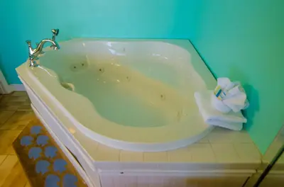 a bath tub with a towel sitting inside of it at Edgewater 2-0104 'Sandcastle Dreams' in Panama City Beach