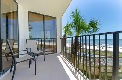 a balcony with two chairs and a view of the beach at Edgewater 2-0104 'Sandcastle Dreams' in Panama City Beach