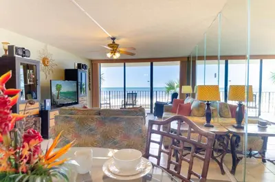 a living room with a view of the ocean at Edgewater 2-0104 'Sandcastle Dreams' in Panama City Beach