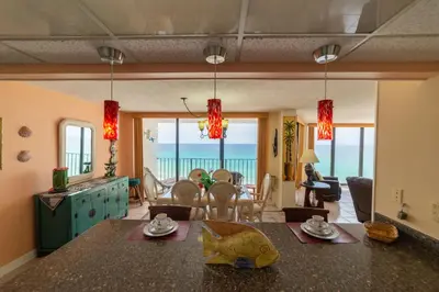 a kitchen and living room with a view of the ocean at Edgewater 2-0811 'Beach Lovers Paradise' in Panama City Beach