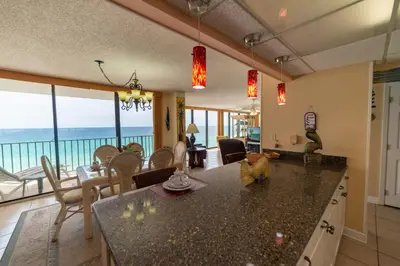a kitchen and dining room with a view of the ocean at Edgewater 2-0811 'Beach Lovers Paradise' in Panama City Beach