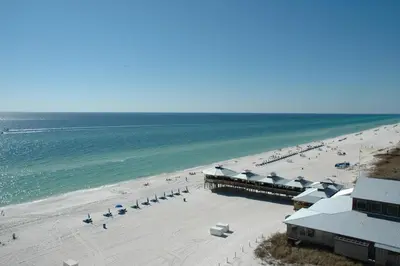 an aerial view of a beach with chairs and umbrellas at Sunbird 0908W 'Captain's Cove' in Panama City Beach