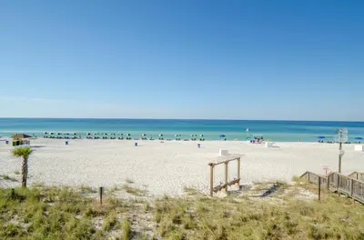 a beach with a bunch of people in the water at Sunbird 0908W 'Captain's Cove' in Panama City Beach