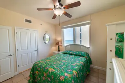a bedroom with a bed and a ceiling fan at Shores of Panama 0801 'Panama Dreamin' in Panama City Beach