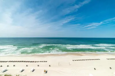 a view of a beach with chairs and the ocean at Shores of Panama 0801 'Panama Dreamin' in Panama City Beach