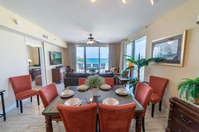a dining room with a table and chairs and the ocean at Shores of Panama 0201 'Down By the Sea' in Panama City Beach
