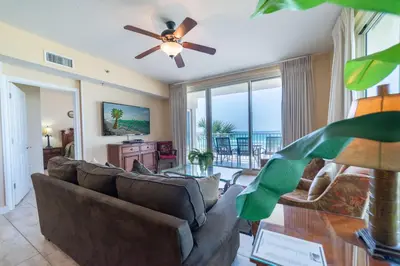 a living room with a couch and a ceiling fan at Shores of Panama 0201 'Down By the Sea' in Panama City Beach