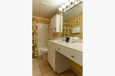a bathroom with a sink and a toilet at Shores of Panama 0817 'Sunset Lagoon' in Panama City Beach