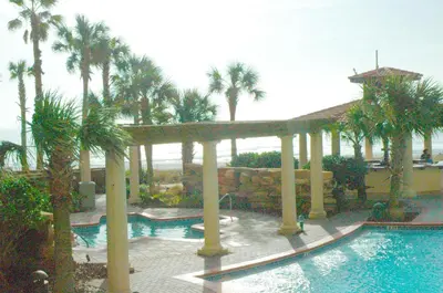 a resort with a swimming pool and palm trees at Shores of Panama 0817 'Sunset Lagoon' in Panama City Beach