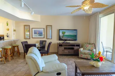 a living room with a couch and a tv at Shores of Panama 0817 'Sunset Lagoon' in Panama City Beach