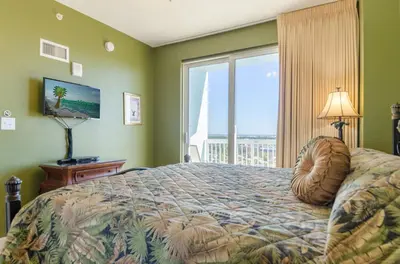 a bedroom with a bed and a large window at Seychelles 1801 'Turtle Cay' in Panama City Beach