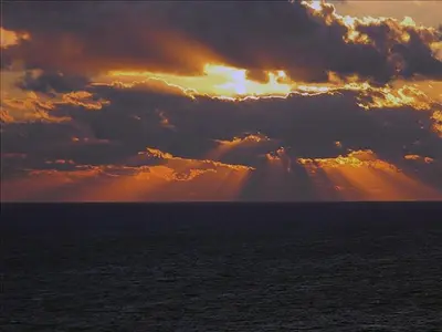 a cloudy sky over the ocean with the sun poking through at Seychelles 1801 'Turtle Cay' in Panama City Beach