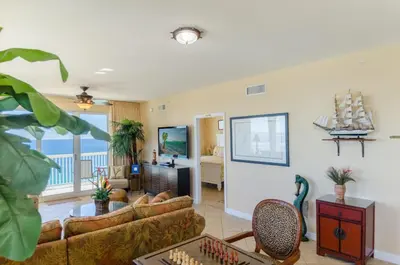a living room with couches and a chessboard at Seychelles 1801 'Turtle Cay' in Panama City Beach