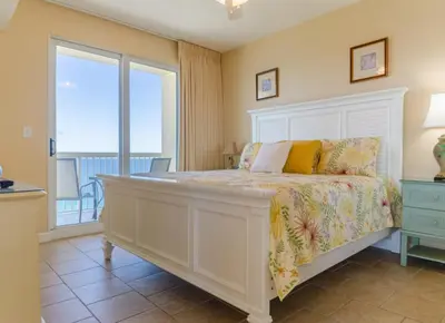 a bedroom with a bed with a view of the ocean at Seychelles 1801 'Turtle Cay' in Panama City Beach