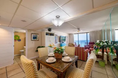 a living room with a table and chairs at Edgewater 2-0904 'Sea Breeze' in Panama City Beach