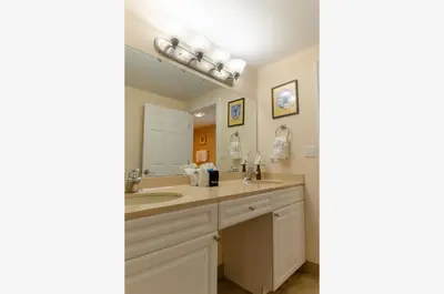 a bathroom with a sink and a mirror at Boardwalk 2111 'Seaside Memories' in Panama City Beach