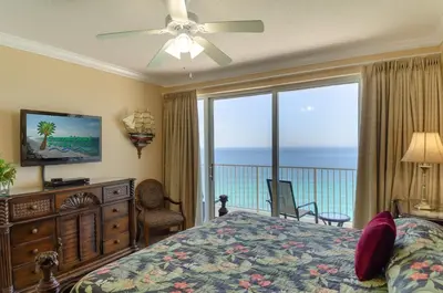 a bedroom with a bed and a large window with the ocean at Boardwalk 2111 'Seaside Memories' in Panama City Beach