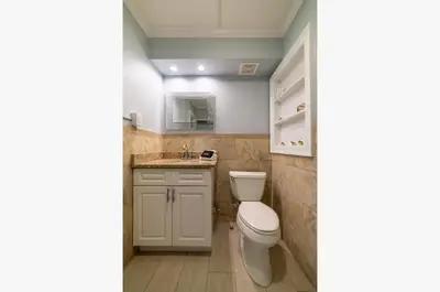 a bathroom with a toilet and a sink at Emerald Beach Cottage in Panama City Beach