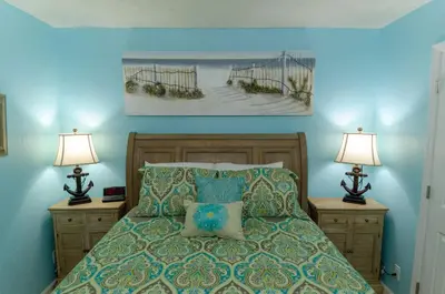 a bedroom with a bed with two lamps on night stands at Sunbird 509E 'Window on the Gulf' in Panama City Beach