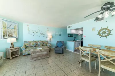 a living room with a couch and a table at Sunbird 509E 'Window on the Gulf' in Panama City Beach