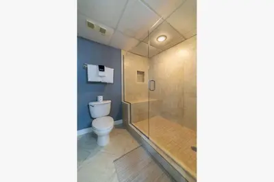 a bathroom with a shower and a toilet at Long Beach T4-1004 'Emerald Retreat' in Panama City Beach