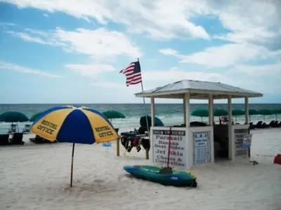 an umbrella and a lifeguard station on the beach at Commodore 1303 'Rest Ashored' in Panama City Beach