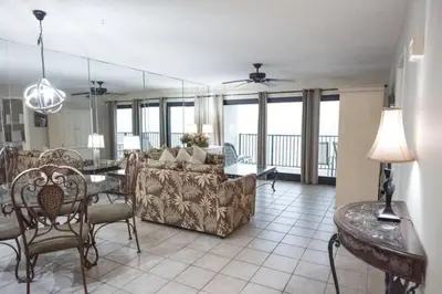 a living room with a couch and a table at Commodore 1303 'Rest Ashored' in Panama City Beach